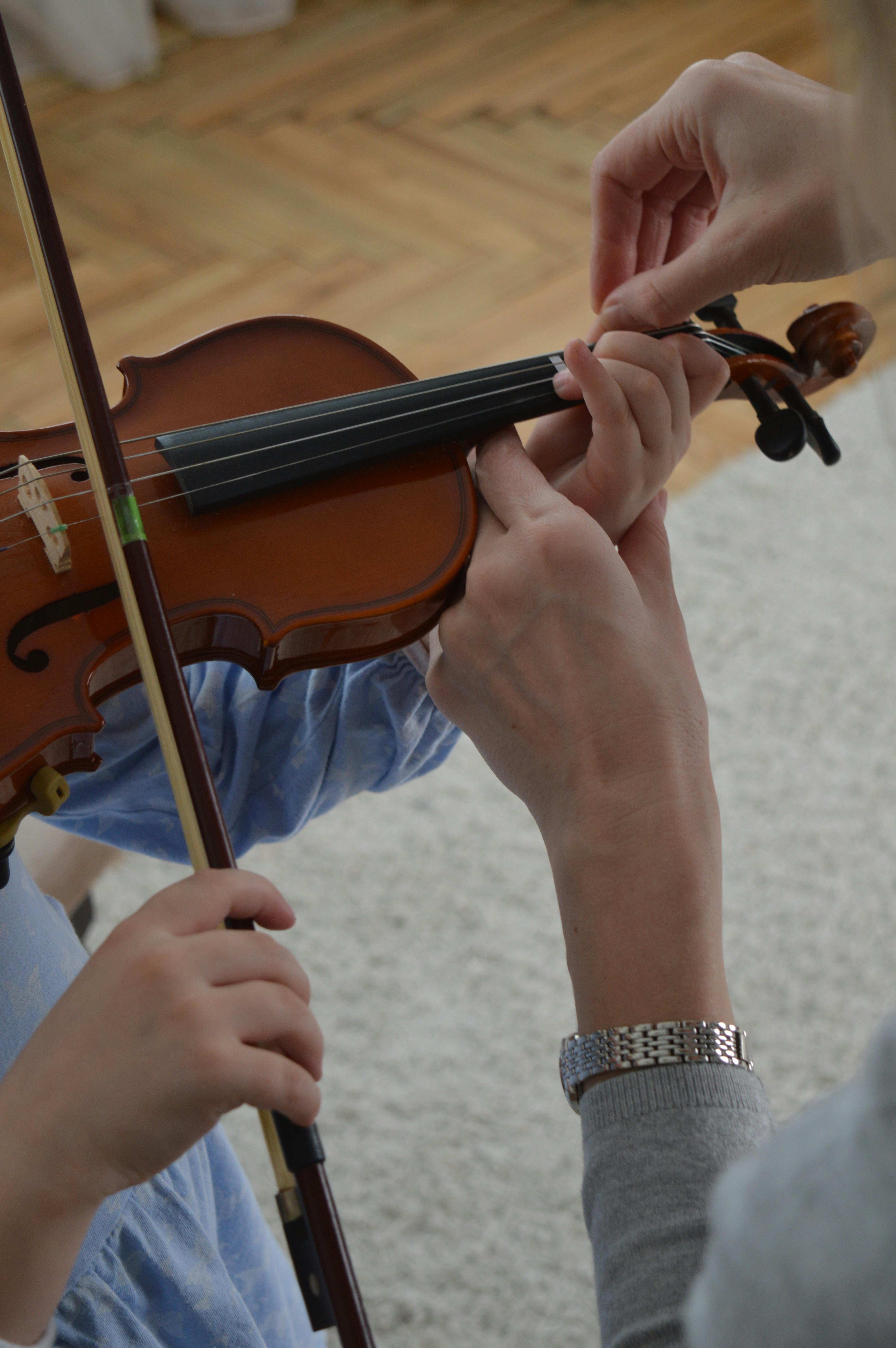 Private violin lesson focusing on finger placement and hand position