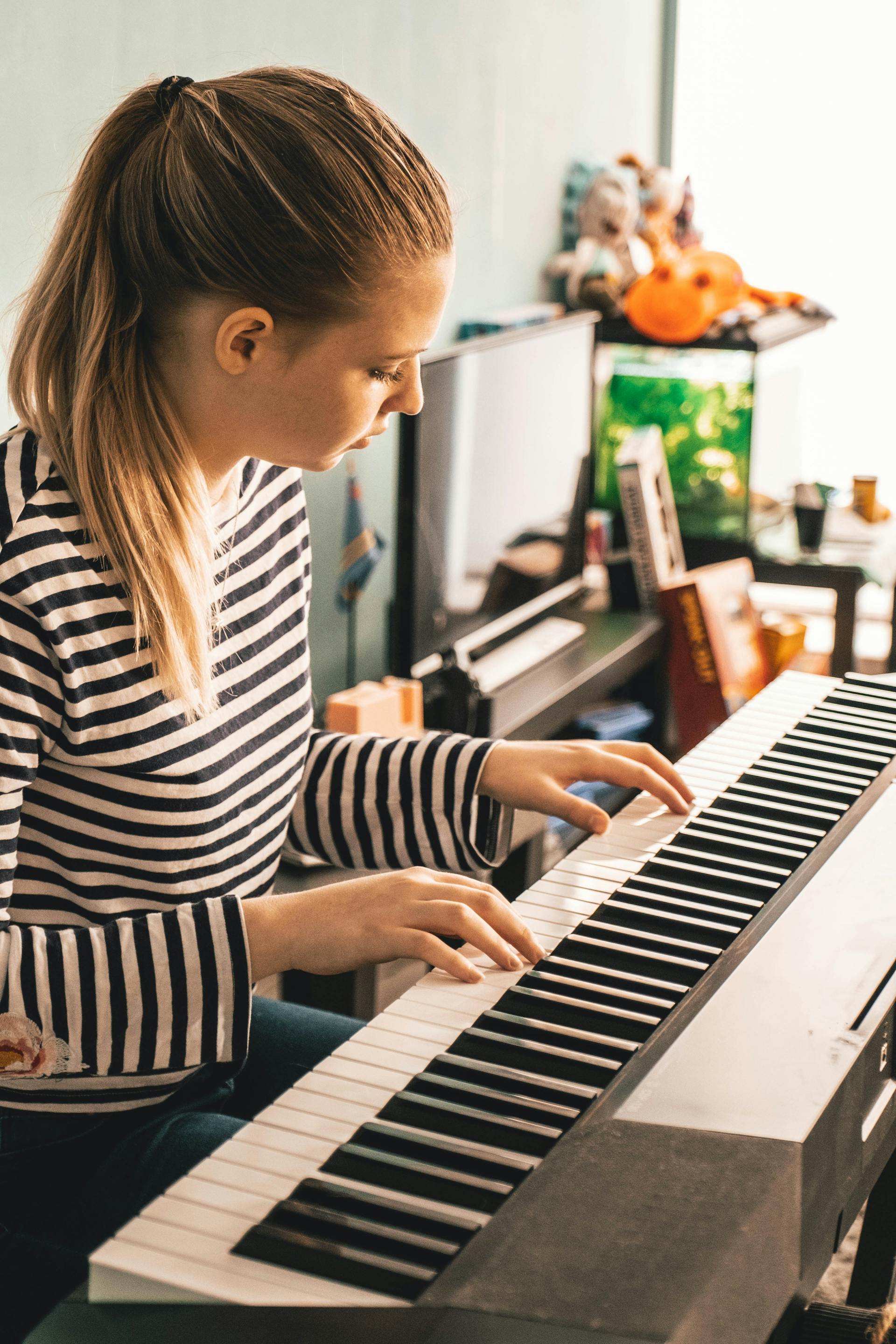 Adult piano student practicing during a private lesson
